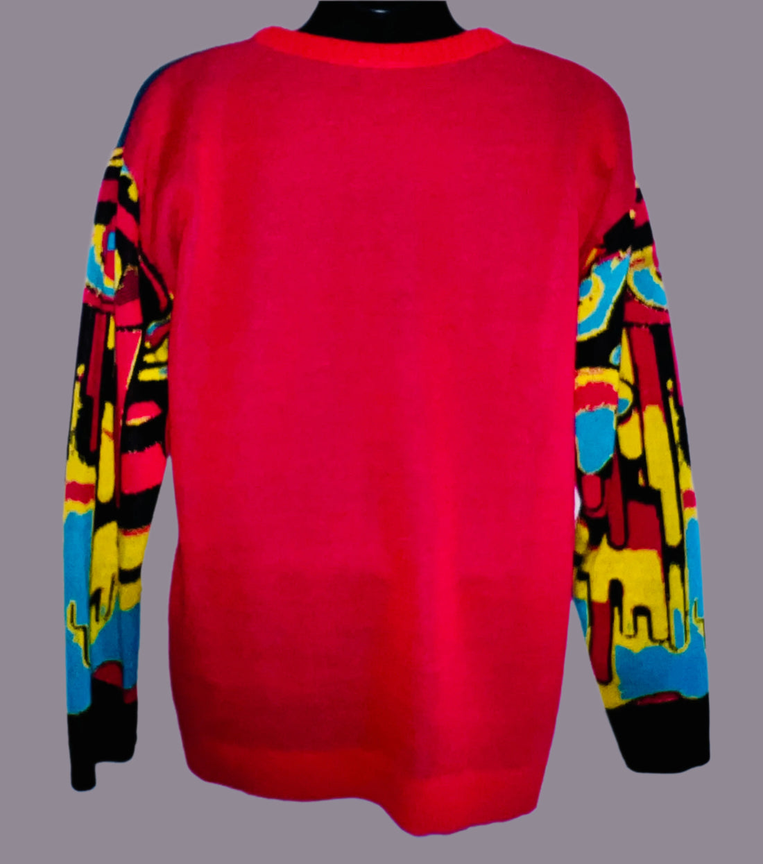 Red sweater with colorful sleeves on a mannequin against a white background