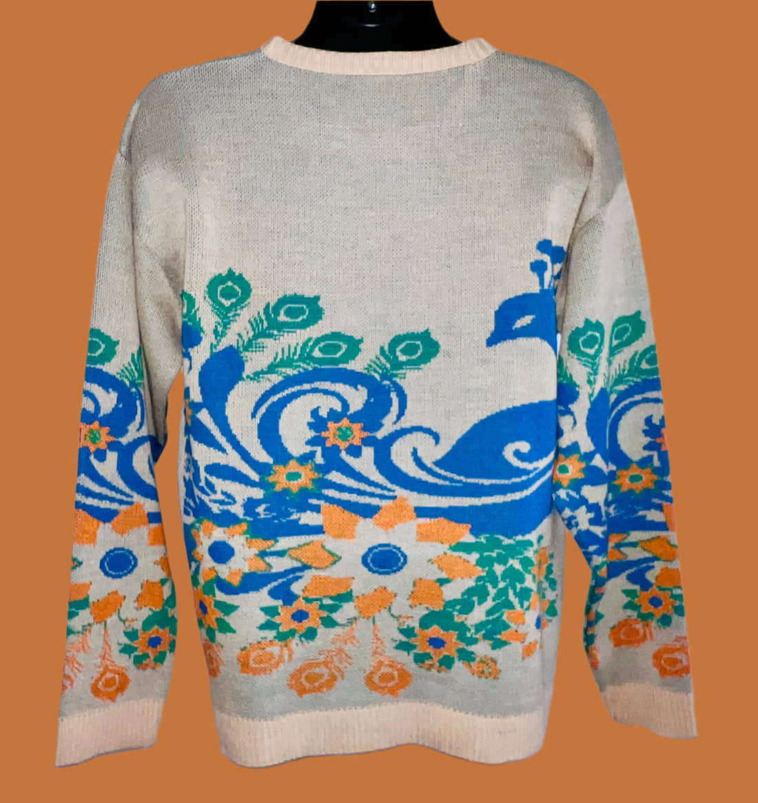 Sweater with peacock design on a white background