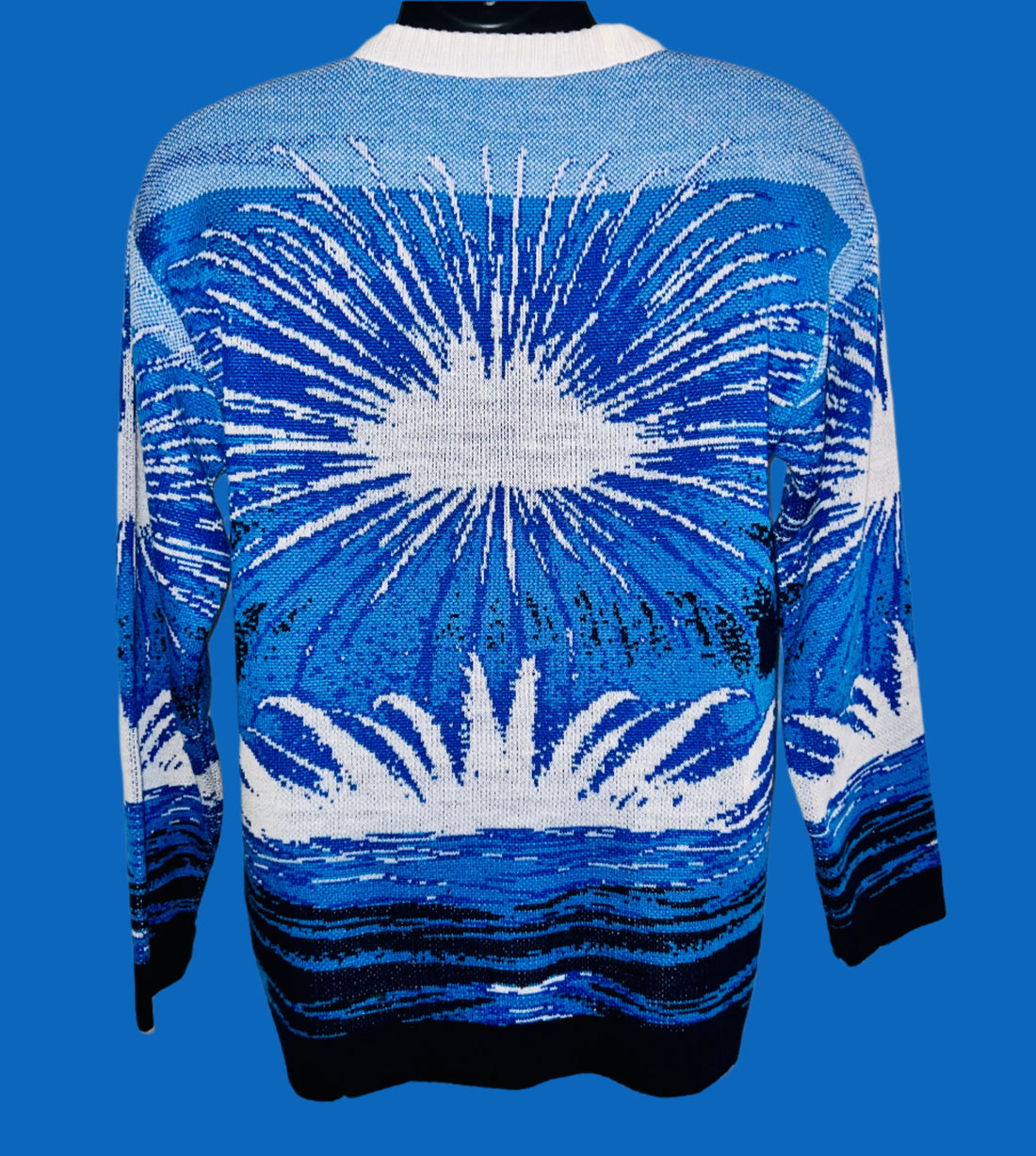 Blue and white patterned sweater on a mannequin against a white background