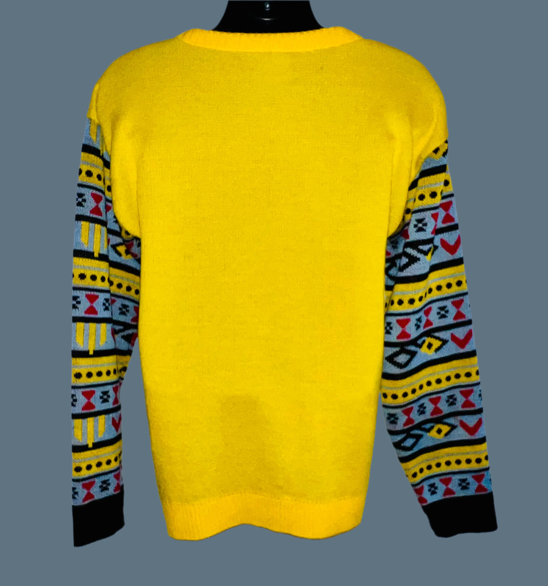 Yellow sweater with patterned sleeves on a white background