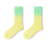 Pair of gradient socks transitioning from green to yellow on a white background
