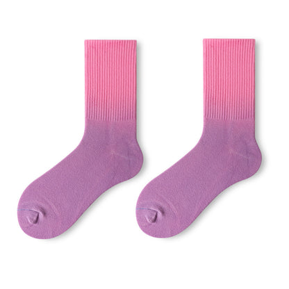 Pair of pink and purple gradient socks on a white background