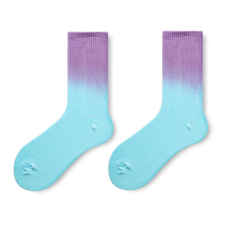 Pair of socks with a gradient from purple to blue on a white background