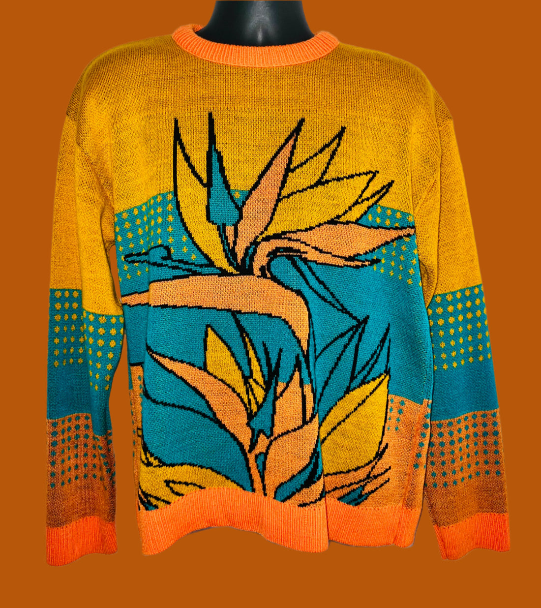 Colorful sweater with leaf design on a white background