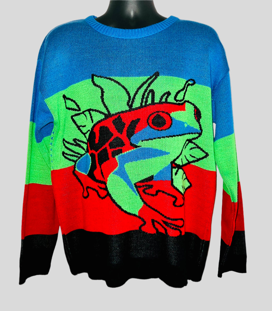 Colorful sweater with a graphic design on a mannequin against a white background