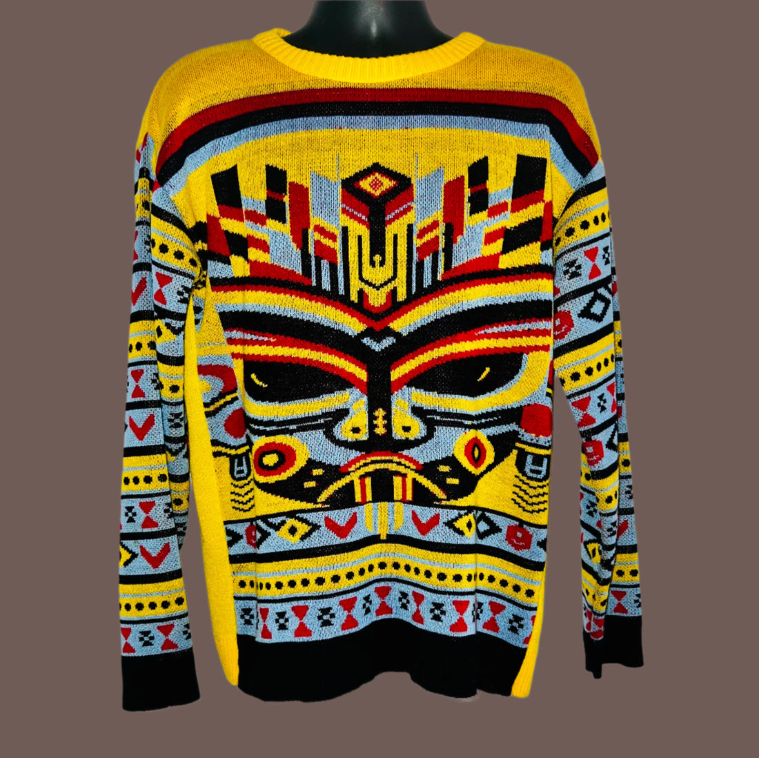 Colorful sweater with geometric pattern on a white background