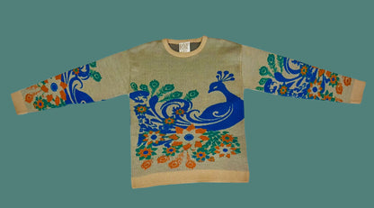 Sweater with peacock design on a white fabric background