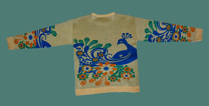 Sweater with peacock design on a white fabric background