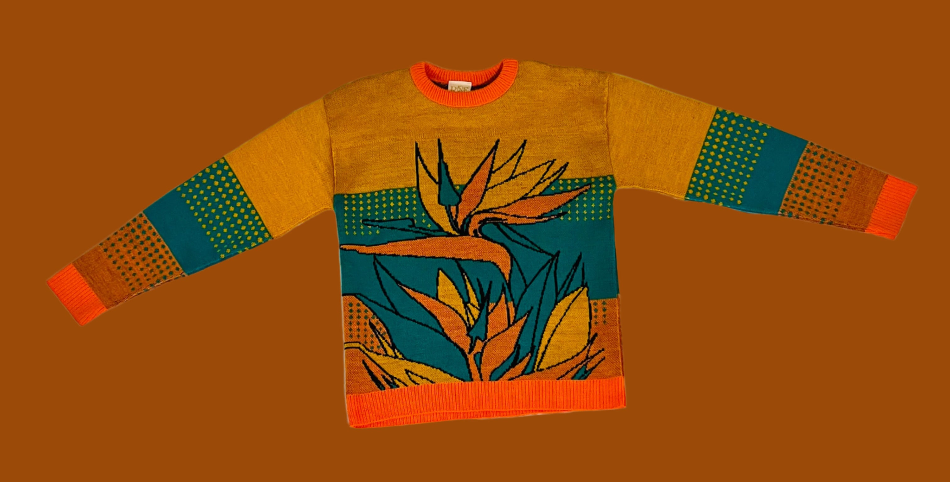 Colorful sweater with abstract design on a white fabric background
