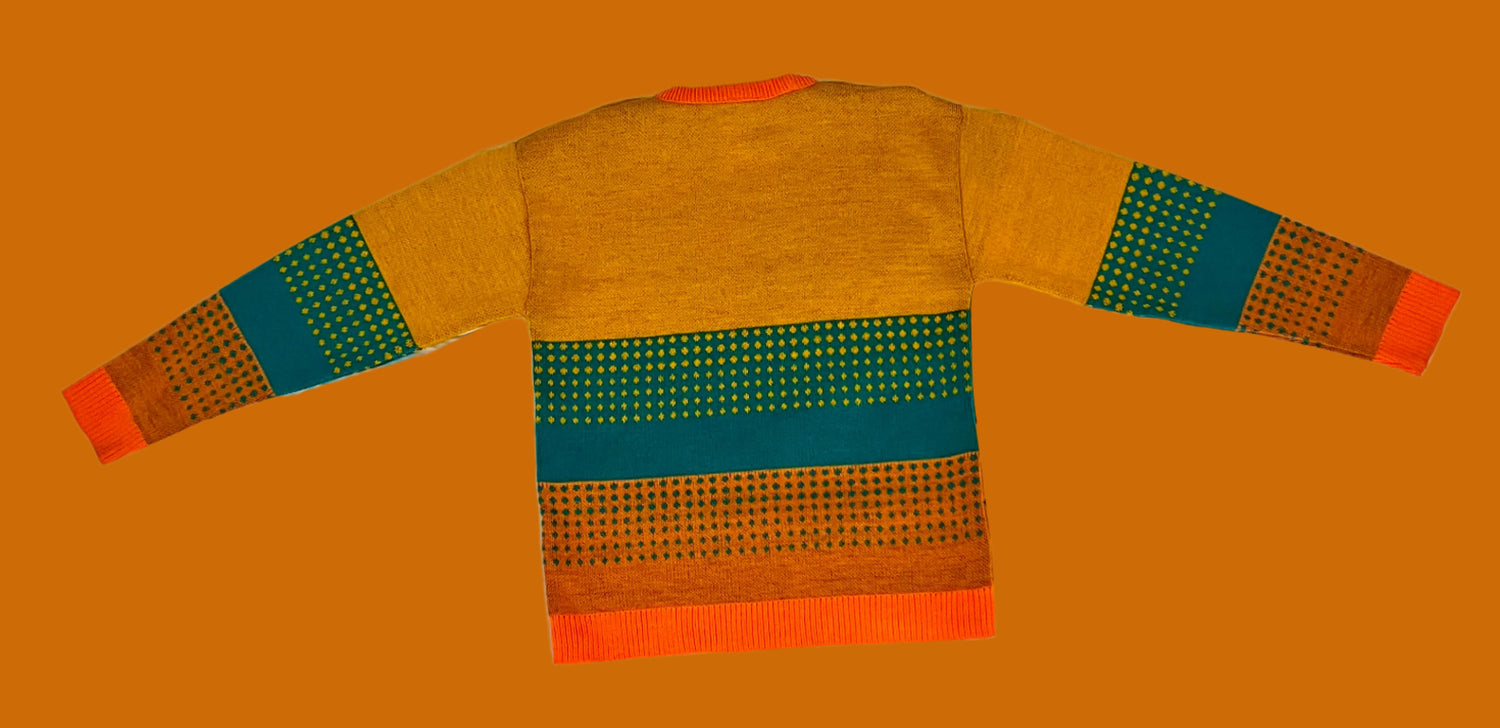 Colorful sweater with patterned design on a white textured surface