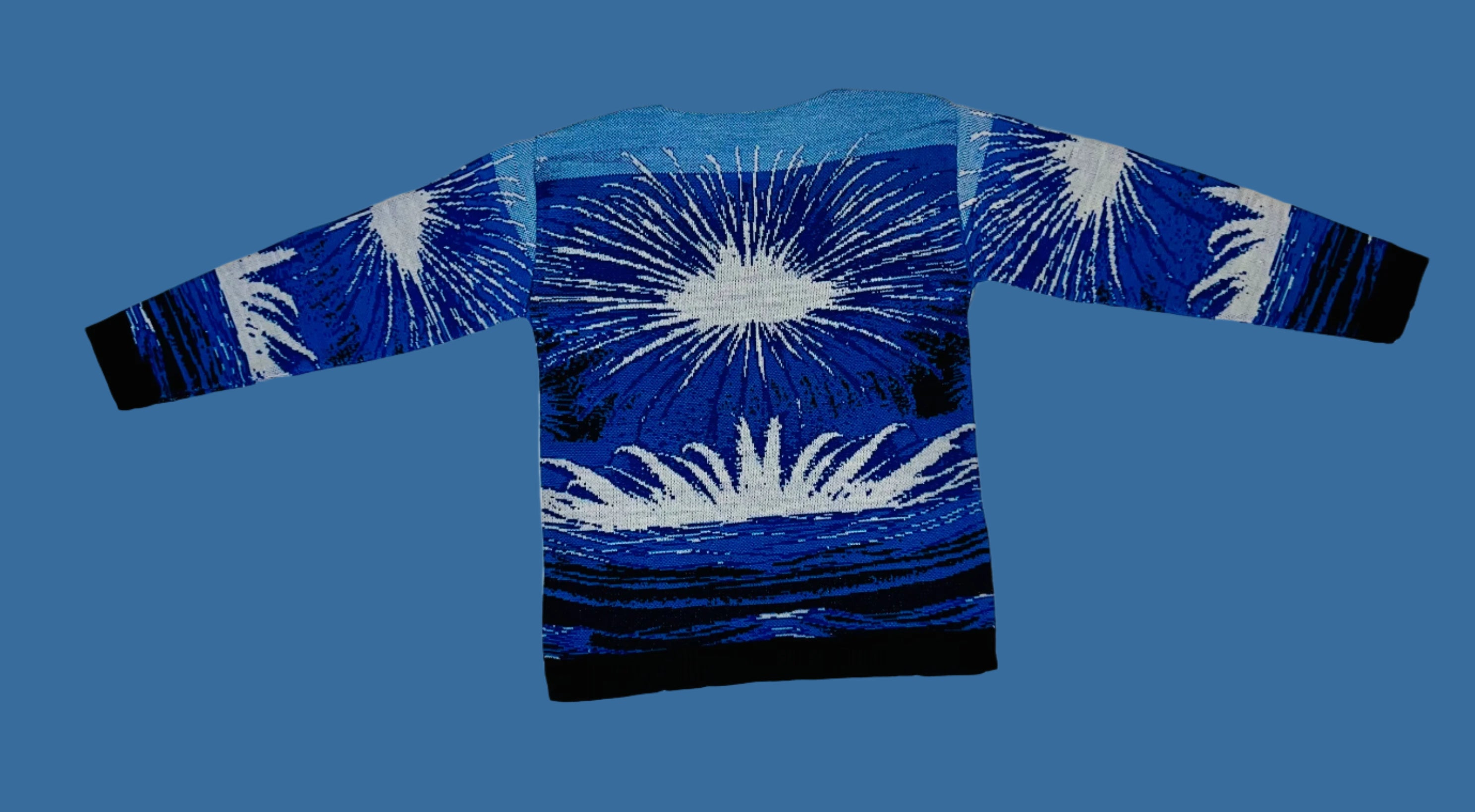 Blue and black long-sleeve shirt with white abstract design on a textured white background