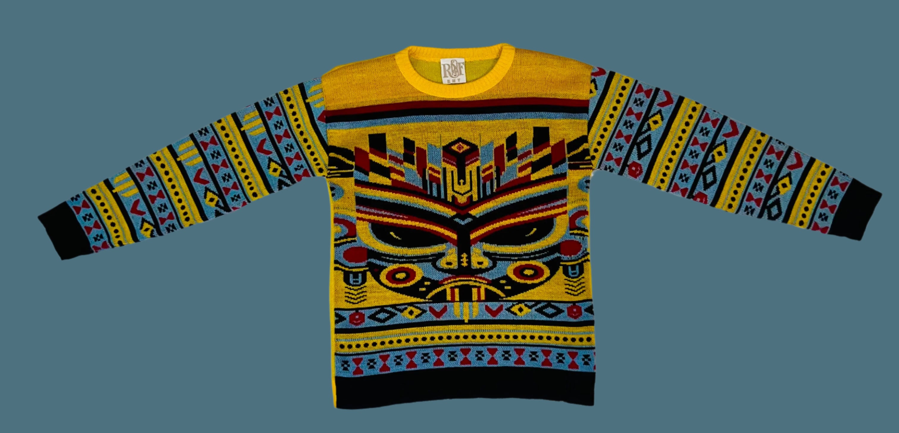 Colorful sweater with geometric pattern on a white fabric background